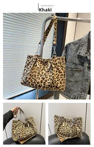Detail of khaki leopard print tote with pearl and metal chain strap on corduroy