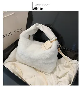 Detailed view of white plush faux fur handbag with knotted handle in premium gift box