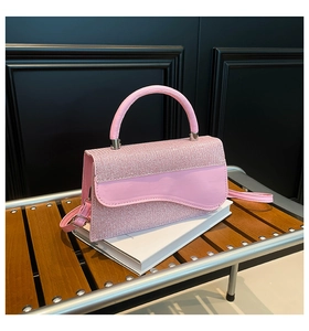 Détail du sac en tissu tissé rose et cuir verni avec boucle argentée et rabat ondulé