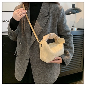 Plush cream crossbody bag styled with a tailored blazer for a chic autumn outfit