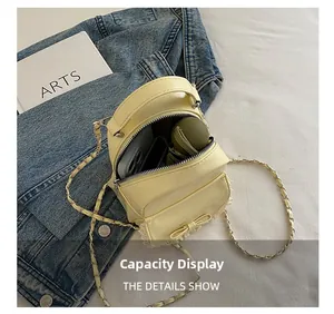 Yellow mini leather bag showing internal storage capacity for phone and umbrella