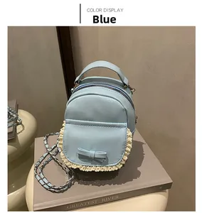 Close-up of blue faux leather backpack with lace trim and elegant bow detail