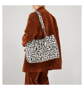 Detail of leopard print tote with elegant metal chain and pearl shoulder strap