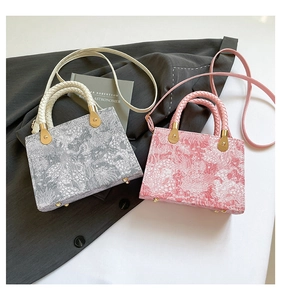 Close-up of vintage floral jacquard handbags with woven handles and gold metal studs