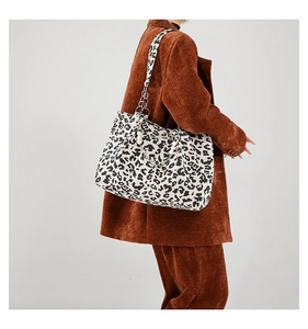 Detail of leopard print tote bag with pearl bead and silver chain decorative strap