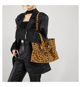 Detail of leopard print corduroy tote bag with pearl chain shown on model