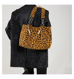 Detailed back view of leopard print tote bag with pearl handle and chain strap