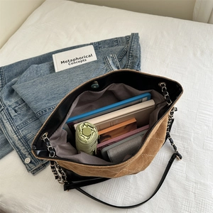 Brown suede tote bag with chain strap and large capacity shown from 45-degree angle