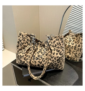 Detail of leopard print corduroy tote bag with silver chain and velvet texture