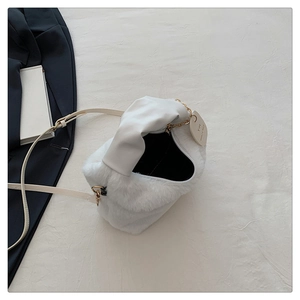 Gros plan du sac en peluche blanc avec texture douce et détail élégant de chaîne dorée