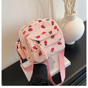 Detail of pink corduroy mini crossbody bag with strawberry print and braided zipper pull