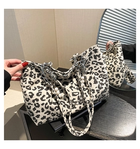 Detail of leopard print tote bag with pearl chain strap and corduroy texture