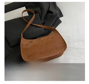 Detail show of the brown animal embossed leather texture on a stylish underarm bag