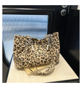 Detail of leopard print tote bag with metallic chain and pearl bead shoulder strap
