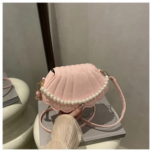 Pink shell shaped crossbody bag with snakeskin texture and pearl embellishment detail