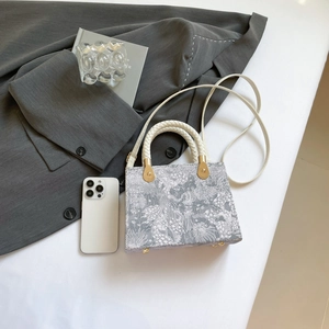 Elegant rectangular embroidered jacquard handbag with white straps and gold hardware