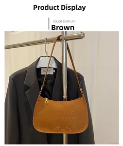 Close-up of brown faux snake-skin texture and gold zipper on a chic shoulder bag