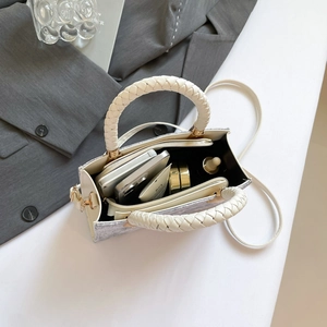 Chic silver woven jacquard crossbody bag with off-white leather handles and interior space