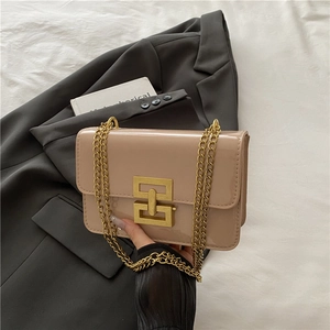 Beige patent leather crossbody bag with chunky gold chain strap and geometric lock