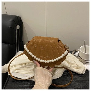 Close-up of brown shell bag featuring snake texture and elegant white pearl handle decoration