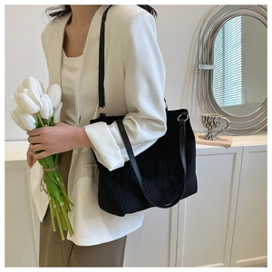 Quilted black tote bag detail with large capacity and shoulder straps for daily styling