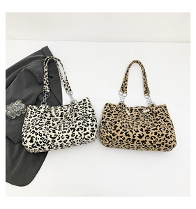Detail of leopard print corduroy tote bag with pearl chain and metallic accents
