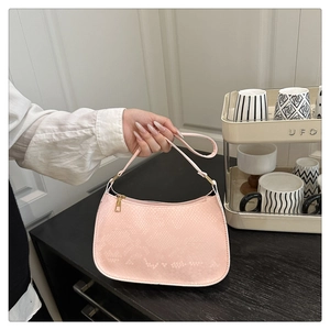 Close-up of pink snakeskin pattern texture with golden buckle and zipper detail