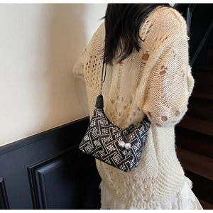 Detail of retro geometric pattern shoulder bag with pearls on a vintage staircase