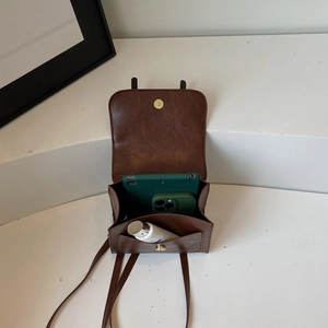 Brown vintage leather backpack featuring interior compartments for tablet and accessories