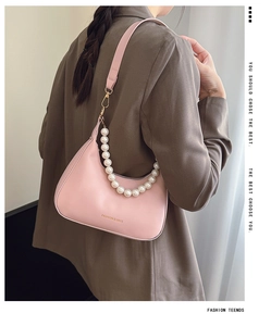 Detail of pink hobo bag with large faux pearl chain strap and leather shoulder strap