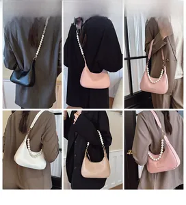Detail of hobo bag with large artificial pearl chain and adjustable PU leather strap