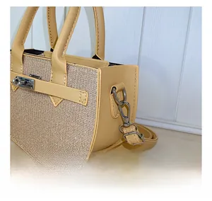 Detailed macro view of beige crossbody bag showing silver metal hook and glitter texture