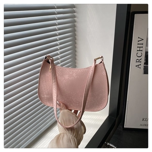 Detailed macro view of pink snake pattern texture on synthetic leather shoulder bag