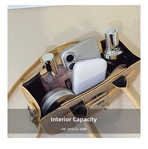 Internal capacity of textured gold handbag with daily essentials and silver buckle