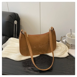 Detail of premium snakeskin texture and gold zipper on a brown shoulder underarm bag