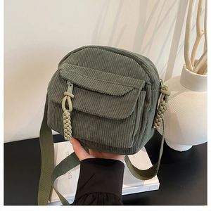 Détail du sac à bandoulière en velours côtelé vert armée avec rabat texturé et zip tressé