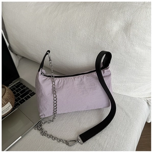 Close-up of light purple nylon shoulder bag with silver chain and black strap details
