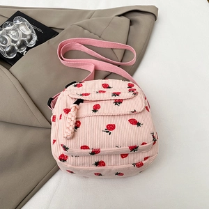 Pink corduroy mini crossbody bag with red strawberry print and adjustable strap