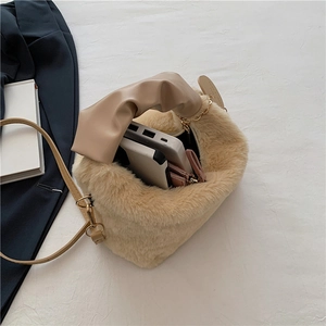 Beige faux fur tote bag with pleated leather handle and gold chain detail on white fabric
