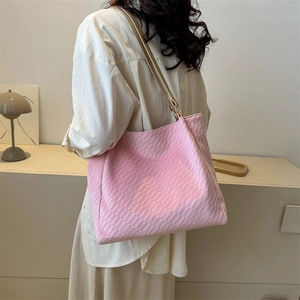 Pink woven tote bag for women with embossed grid texture and slim shoulder straps