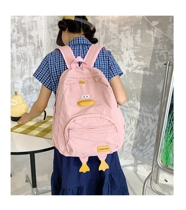 Detailed back view of pink cartoon duck school backpack with yellow beak and feet details