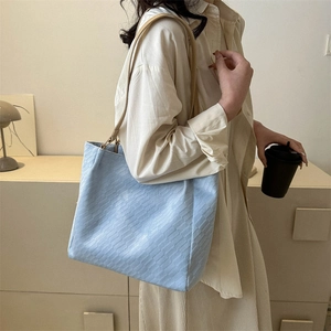 Light blue large tote bag with brick texture and beige straps for casual office use