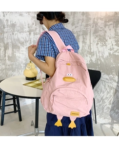 Close-up of pink cartoon duck backpack with 3D yellow beak and paws detail for school