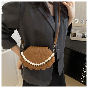 Brown shell-shaped crossbody bag with snake-embossed texture and pearl strap detail