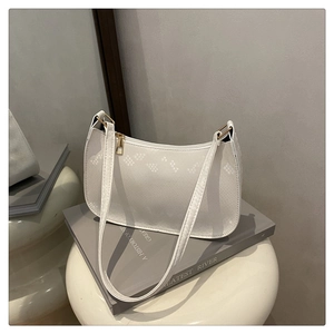 Detail of white snakeskin texture faux leather bag with gold hardware and crescent shape
