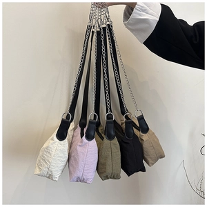 Detailed view of lightweight nylon underarm bags in five colors with silver chain straps