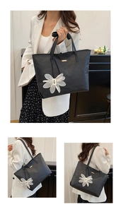 Three views of a black minimalist tote bag with a white flower charm and thin straps