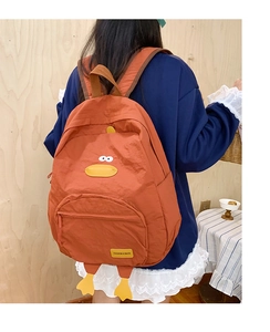 Detail of cute duck-shaped backpack in orange-brown canvas with 3D webbed feet accents