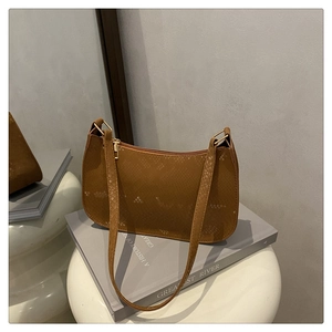 Close-up of brown snakeskin textured leather baguette bag with gold zipper detail
