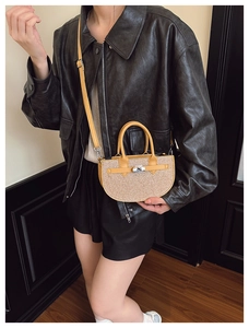 Detail of glitter saddle bag with silver metal twist lock and yellow leather strap